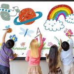 Children drawing colorful space and nature scene on a large interactive whiteboard in a classroom.